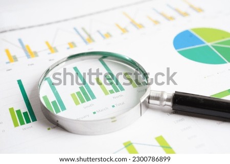 Magnifying glass on charts graphs paper. Financial development, Banking Account, Statistics, Investment Analytic research data economy.
