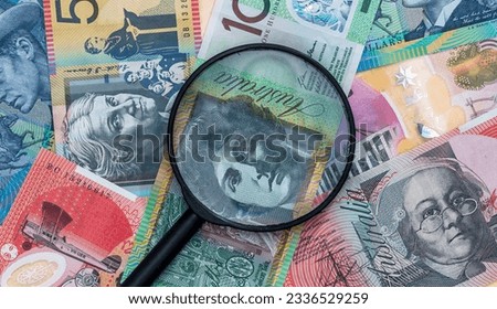 magnifying glass on color different aud australian banknotes, financial concept. AUD Money