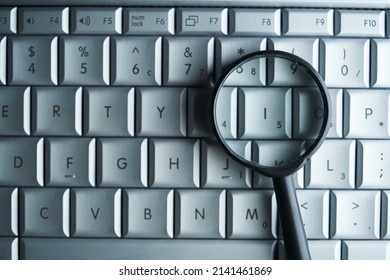 magnifying glass on computer keyboard                  