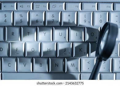 magnifying glass on computer keyboard                  