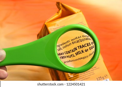 Magnifying Glass On Food Ingredients And Additives Label.  Reading Ingredients List On Food Package With Magnifying Glass.
