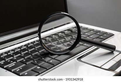 Magnifying glass on the laptop keyboard. 