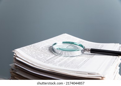 magnifying glass on the newspaper
 - Powered by Shutterstock