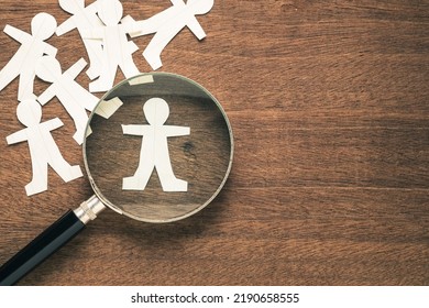 Magnifying Glass On Paper Human Dolls, Only One Is In The Focus, Search The Talent People, Man Selection, Recruitment And HR Concept