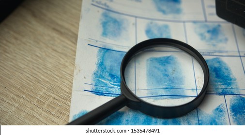 Magnifying Glass On Police Crime Page File.Crime And Violence Concept.