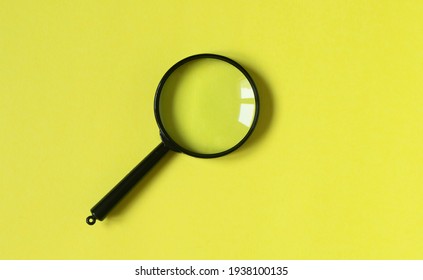 Magnifying Glass On Trendy Yellow Background, Top View.