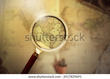 Magnifying glass on vintage retro USA map and currency. Vintage camera on antique America map.