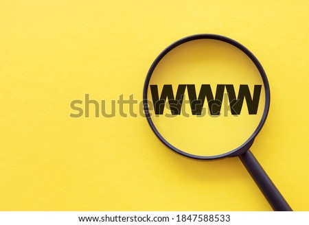 Magnifying glass on a yellow background with the text www.