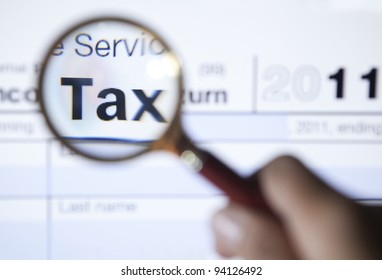 Magnifying glass over the word tax on form 1040