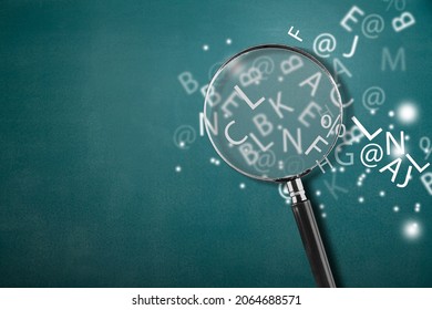 A Magnifying Glass With Part Of Scattered English Alphabet Letters On The Desk Background