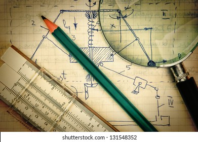 magnifying glass and a slide rule on the old page with the calculations in mechanics - Shutterstock ID 131548352