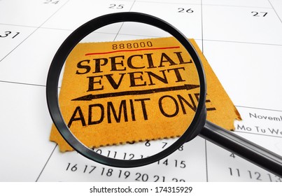 Magnifying Glass And Special Event Ticket Stub On A Calendar                               