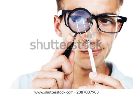 Magnifying glass, technician and hand of man with cables or problem solving in white background. Studio, electrician or working with electricity, wires or search for solution or check for power