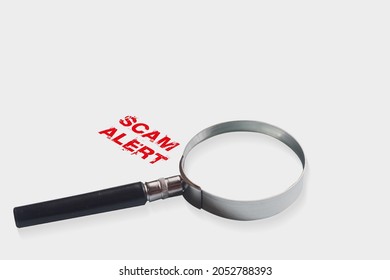 Magnifying Glass With Text Scam Alert