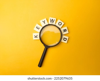 Magnifying glass and toys word with the word KEYWORD on yellow background - Shutterstock ID 2252079635