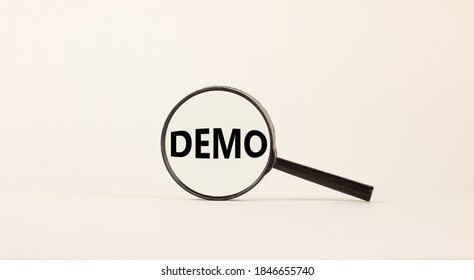 Magnifying glass with word demo on beautiful white background. Business concept, copy space.