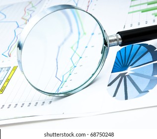 magnifying glass and the working paper with a diagram - Powered by Shutterstock