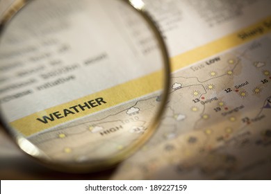 Magnifying Weather Report In Newspaper