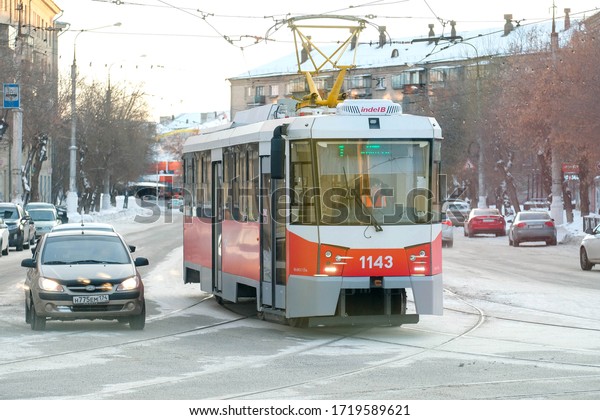 Magnitogorsk, Russia - 08/02/2020: Tram at the\
crossroads. Street traffic in\
winter.