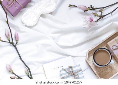 Magnolia flower flat lay morning in bed concept composition. Top view
