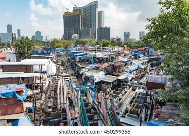 The Mahalaxmi Dhobi Ghat, or outdoor laundry, is considered to be the largest of its kind in the world. The historic dhobi ghat contrasts with the tall buildings of modern Mumbai in the background. - Shutterstock ID 450299356