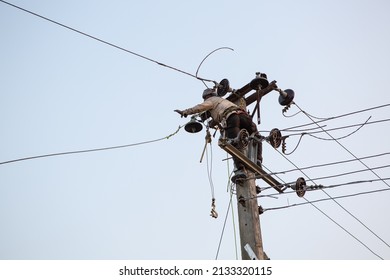 MAHANAUR, NEPAL - FEBRUARY 27, 2022: An Electrician Fixes Power Lines In Mahanaur, A Rural Village In Nepal's Terai Region. Nepal Relies On Its Hydro Energy Sector To Meet Its Electricity Consumption.