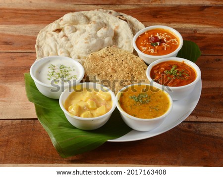Maharaja Veg Thali from an indian cuisine, food platter consists variety of veggies,paneer dish, lentils,rice,roti, sweet dish, snacks etc., selective focus