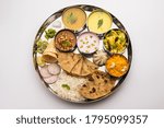 Maharashtrian food Thali or platter - Mumbai style Meal from Indian State Maharashtra includes, roti, rice, dal, sabji, sweet roti and rice, kadhi, Modak, papad etc