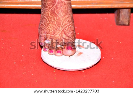 Maharashtrian Wedding Ritual - Shila Arohan ritual - An Indian bride step onto a stone slab and counsels her to prepare herself for a new life