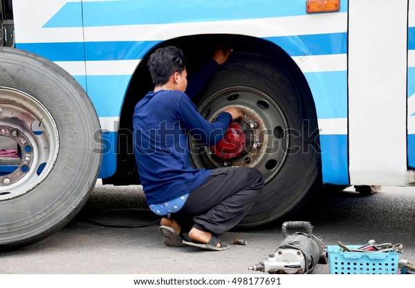 MAHASARAKHAM,\
THAILAND - MAY 3 : Thai mechanic people repairing and fix change\
wheel tire of bus broken and explosion on the road at countryside\
on May 3, 2015 in Mahasarakham,\
Thailand