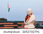 Mahatma Gandhi white stature and Indian flag 
