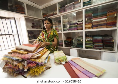 MAHESHWAR, MADHYA PRADESH, INDIA, 17 OCTOBER 2011 : Unidentified Indian woman Worker weaving a saree in a traditional sari factory of Maheshwar, Madhya Pradesh, India.