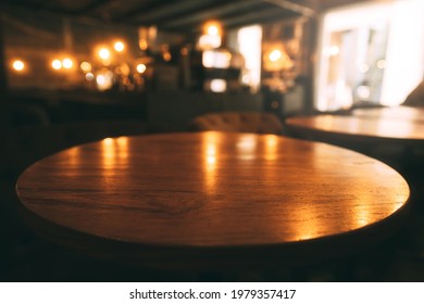 Mahogany Wooden Round Table Surface In Warm Luxury Style Cafe. Blur Bokeh Background With Copy Space For Place Display Product. 