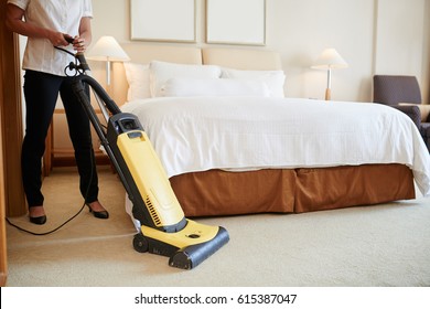 Maid Cleaning Carpet In Hotel Room