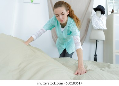 Maid Making Bed In A Nursing Home