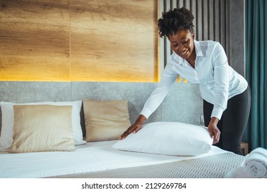 Maid Working Making The Bed At A Hotel. Housekeeper Making The Bed At A Hotel. Female Hand Set Up White Bed Sheet In Bedroom. Chambermaid Making Bed