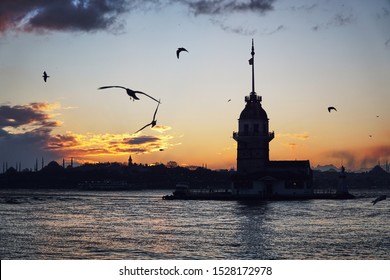 Maiden Tower (Kiz Kulesi) And Silhouette Of Historical Mosques Of Istanbul At The Sunset, In Winter, Turkey