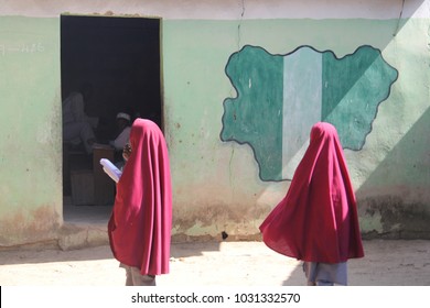 MAIDUGURI, NIGERIA - September 9, 2015: Girl Students Pass A Classroom With The Map And Flag Of Nigeria Painted On It, At Success Private School, One Of The First Schools Attacked By Boko Haram In '09