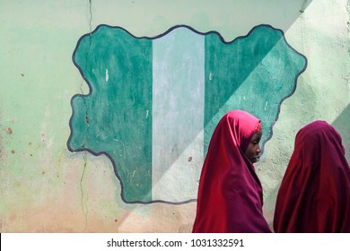 MAIDUGURI, NIGERIA - September 9, 2015: Girl Students Pass A Classroom With The Map And Flag Of Nigeria Painted On It, At Success Private School, One Of The First Schools Attacked By Boko Haram In '09