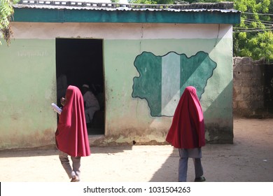 MAIDUGURI, NIGERIA - September 9, 2015: Girl Students Pass A Classroom With A Map And Flag Of Nigeria Painted On It, At Success Private School, One Of The First Schools Attacked By Boko Haram In 2009.