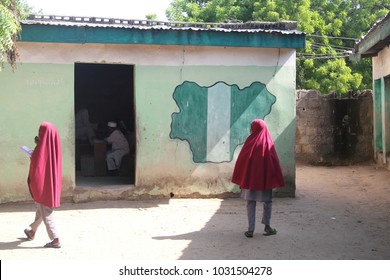 MAIDUGURI, NIGERIA - September 9, 2015: Girl Students Pass A Classroom With A Map And Flag Of Nigeria Painted On It, At Success Private School, One Of The First Schools Attacked By Boko Haram In 2009.