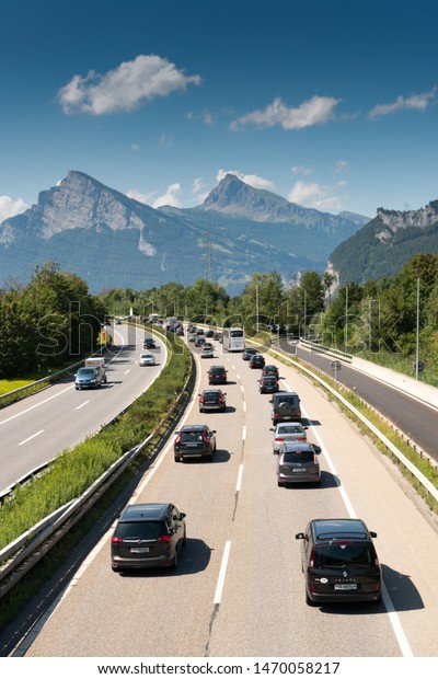 Maienfeld, GR / Switzerland - 4. August 2019:\
traffic jam on a highway in the mountains with many cars and people\
returning home from summer\
holidays