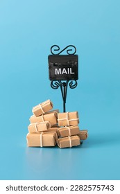 Mail box overflowing with mail, bills, packages, junk mail, e-mails and other unwanted correspondence on blue background. - Shutterstock ID 2282575743