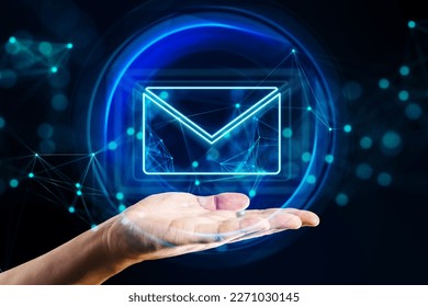 Mail, email and network communication concept with digital glowing envelope symbol in abstract sphere above human hand palm on abstract dark background with blurred dots