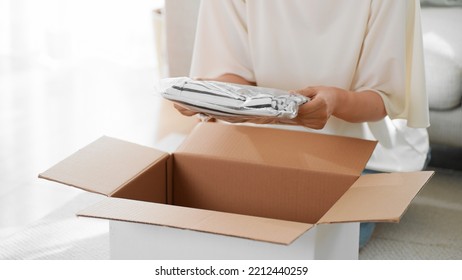 Mail Order Image Of A Woman Opening A Cardboard Box