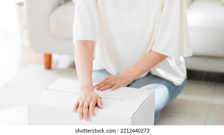 Mail Order Image Of A Woman Opening A Cardboard Box