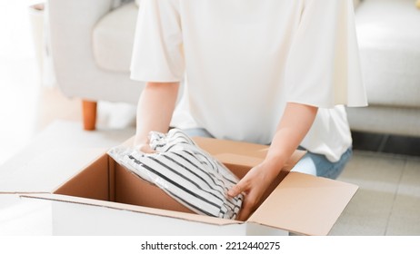 Mail Order Image Of A Woman Opening A Cardboard Box