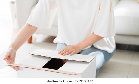 Mail Order Image Of A Woman Opening A Cardboard Box