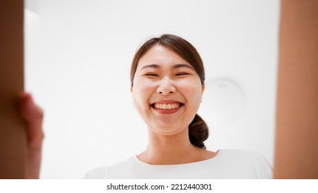 Mail Order Image Of A Woman Opening A Cardboard Box