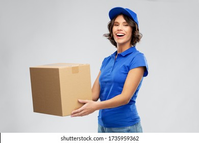 Mail Service And Shipment Concept - Happy Smiling Delivery Girl With Parcel Box In Blue Uniform Over Grey Background